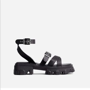 Black strapped sandals with silver detailing.